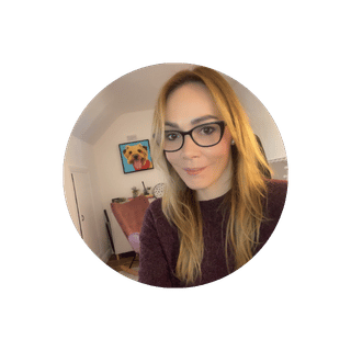 Circular profile picture of a person with glasses in a room.